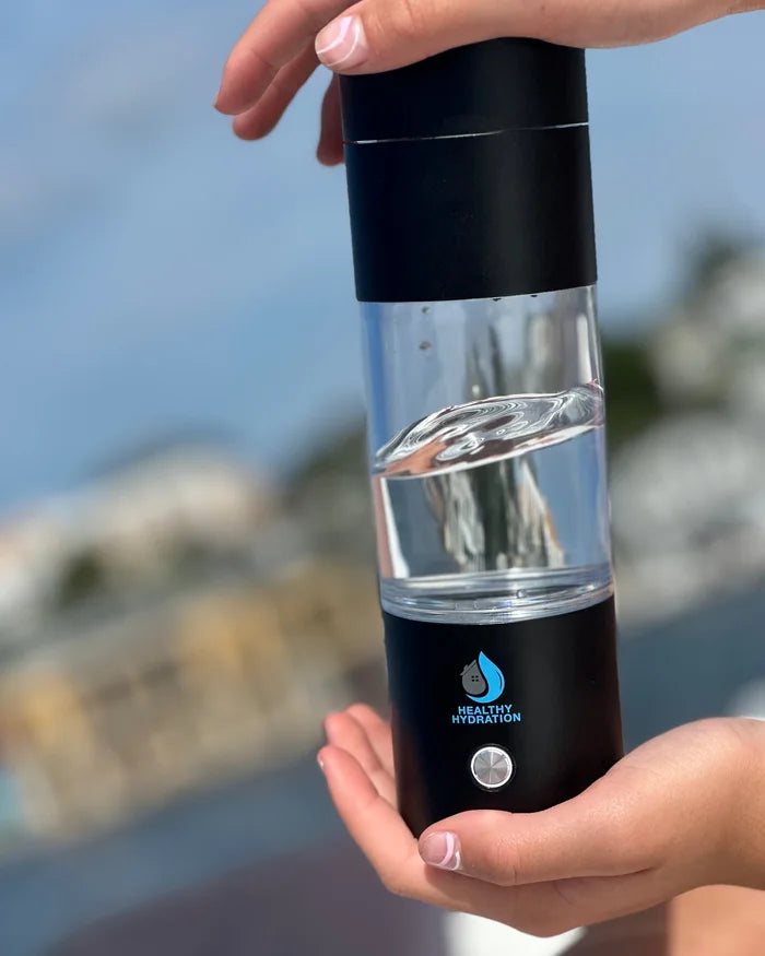 Peak H2 hydrogen water bottle held in two hands