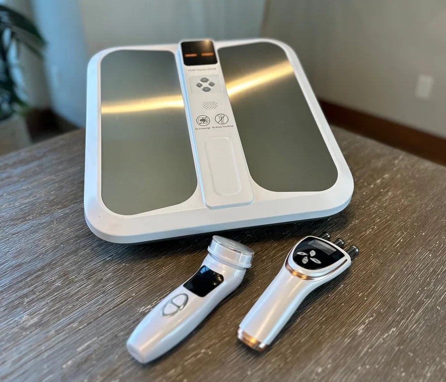 Pulse Pro Plus PEMF mat and two handheld attachments on a wooden table